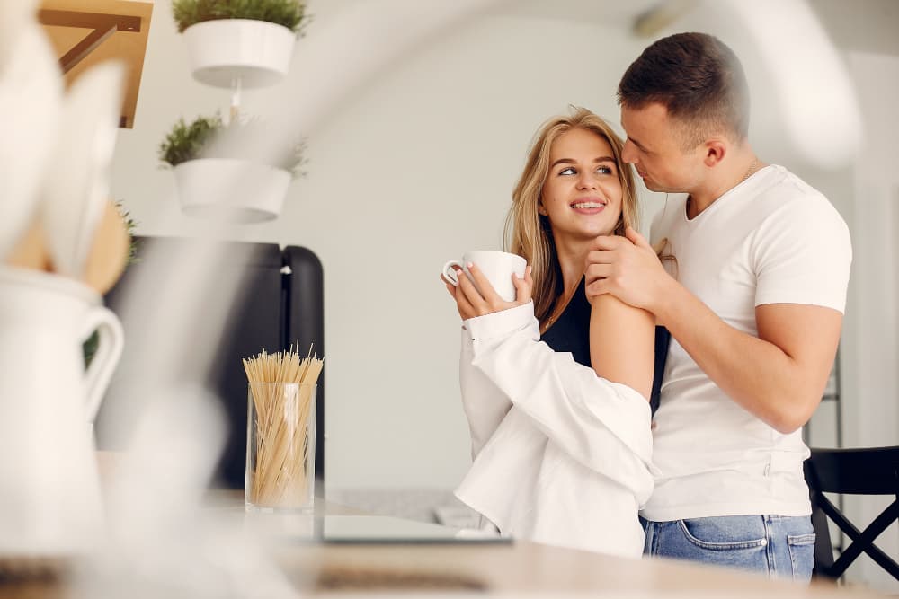 pareja sonrie juntos en una cocina